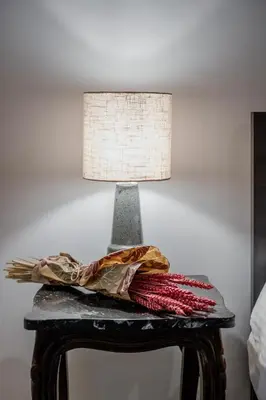 a lamp on top of a table with a pillow at Rouge in Athens