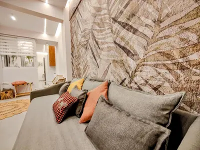 a living room with a couch with pillows at Elpis' cozy & luxury apartment in Athens