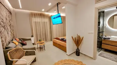 a small living room with a couch and a sink at Elpis' cozy & luxury apartment in Athens