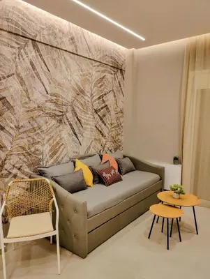 a couch with pillows on it in a living room at Elpis' cozy & luxury apartment in Athens