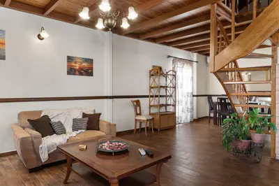 a living room with a couch and a table at Angi&George house in Athens