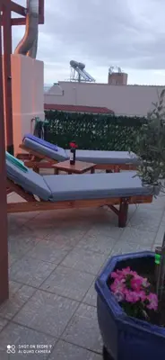 a row of kayaks sitting on a table on a patio at Angi&George house in Athens
