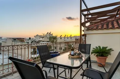 a patio with a table and chairs on a balcony at Angi&George house in Athens