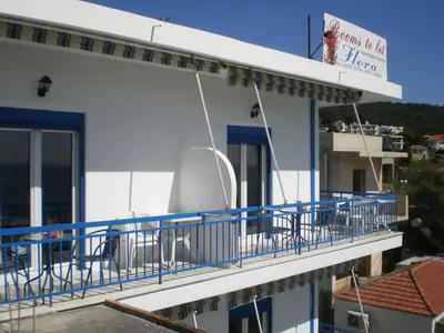 a balcony of a building with blue railing at Sunrise Flora in Agia Marina Aegina
