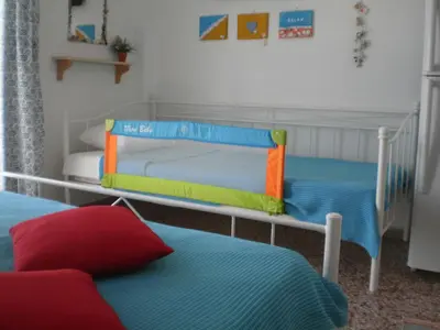 two bunk beds in a room with two beds at Sunrise Flora in Agia Marina Aegina