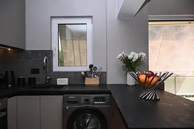 a kitchen with a washing machine and a sink at Cocoon Athenian Riviera by Neuvel in Athens