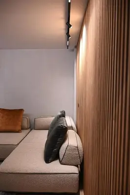 a black pillow sitting on a couch in a room at Cocoon Athenian Riviera by Neuvel in Athens