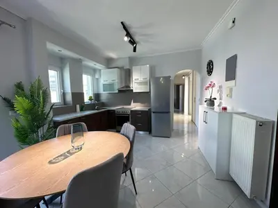 a kitchen and dining room with a wooden table at Redamancy -- PERI009 in Athens