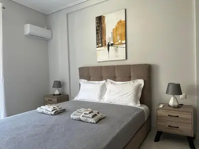 a bedroom with a large bed with two night stands at Redamancy -- PERI009 in Athens