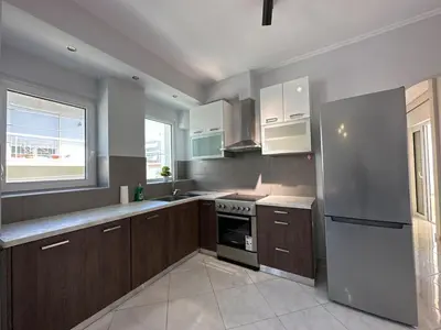 a kitchen with wooden cabinets and a stainless steel refrigerator at Redamancy -- PERI009 in Athens