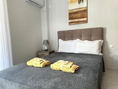 a bedroom with a bed with two towels on it at Redamancy -- PERI009 in Athens