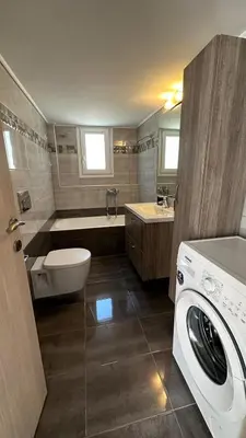 a bathroom with a washing machine and a toilet at Redamancy -- PERI009 in Athens