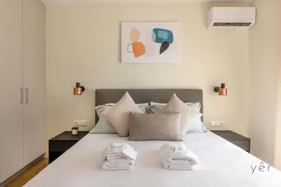 a bedroom with a bed with towels on it at Large 2Bedroom, 2Bathroom Flat with Dining Space & Free Parking in Athens