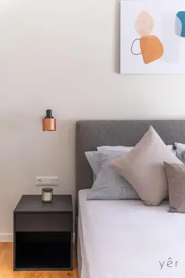 a bedroom with a bed with a night stand next to it at Large 2Bedroom, 2Bathroom Flat with Dining Space & Free Parking in Athens