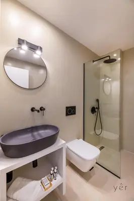 a bathroom with a sink and a toilet and a mirror at Large 2Bedroom, 2Bathroom Flat with Dining Space & Free Parking in Athens