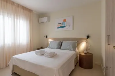 a bedroom with a white bed with towels on it at Large 2Bedroom, 2Bathroom Flat with Dining Space & Free Parking in Athens