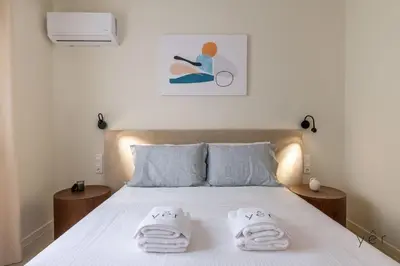 a bedroom with a bed with towels on it at Large 2Bedroom, 2Bathroom Flat with Dining Space & Free Parking in Athens