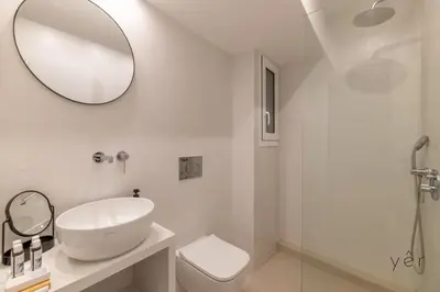 a white bathroom with a sink and a mirror at Large 2Bedroom, 2Bathroom Flat with Dining Space & Free Parking in Athens