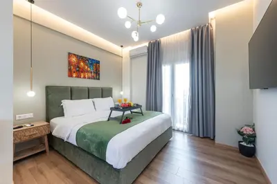 a bedroom with a large bed and a large window at Acropolis Divine Apartments in Athens