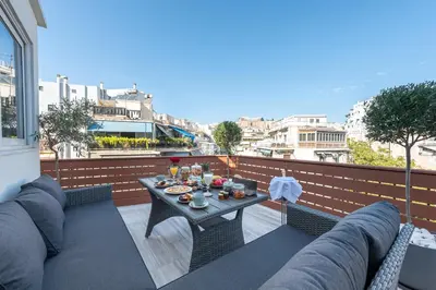 a patio with a table and chairs on a balcony at Acropolis Divine Apartments in Athens
