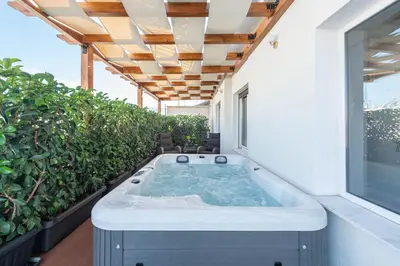 a hot tub on the balcony of a house at Acropolis Divine Apartments in Athens