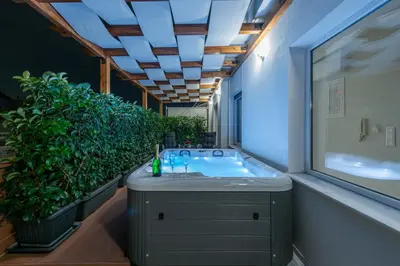 a bathroom with a sink and a large plant at Acropolis Divine Apartments in Athens