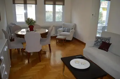 a living room with a table and a couch at Classy apt. Sokratous in Athens