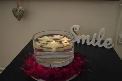 a candle in a glass jar on a table at Classy apt. Sokratous in Athens