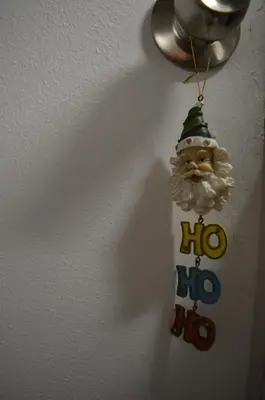 a christmas ornament of a santa claus hanging on a wall at Classy apt. Sokratous in Athens