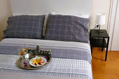 a tray with a plate of food on a bed at Classy apt. Sokratous in Athens