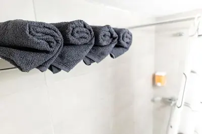 a bunch of towels hanging on a towel rack in a bathroom at Maria's Apartment δίπλα στο Νοσοκομείο Παίδων και στο Λαϊκό in Athens
