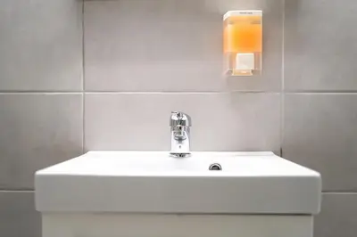 a bathroom with a white sink and a toilet at Maria's Apartment δίπλα στο Νοσοκομείο Παίδων και στο Λαϊκό in Athens