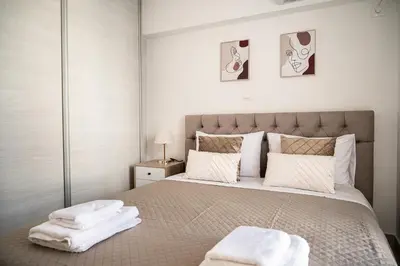 a bedroom with a large bed with towels on it at Waylink Residences - Piraeus Port DRB in Piraeus
