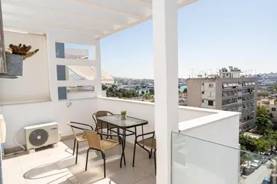 a balcony with a table and chairs and a view at Waylink Residences - Piraeus Port DRB in Piraeus