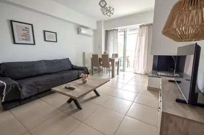 a living room with a couch and a table at Waylink Residences - Piraeus Port DRB in Piraeus