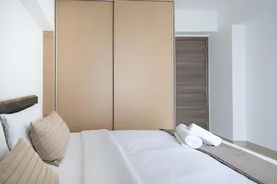 a bedroom with a large white bed with two pillows at Waylink Residences - Piraeus Port DRB in Piraeus
