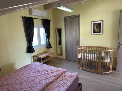 a bedroom with a crib in the corner of a room at GS-Vibes in Porto Rafti