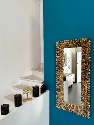 a mirror on a wall in a room with a bathroom at GS-Vibes in Porto Rafti