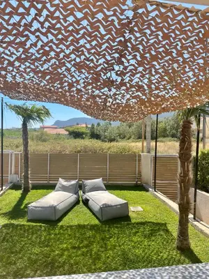 a patio with two couches sitting under a roof at GS-Vibes in Porto Rafti