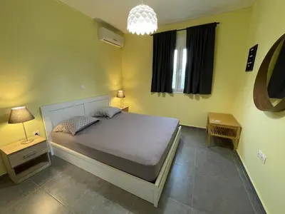 a bedroom with a large bed in a room at GS-Vibes in Porto Rafti