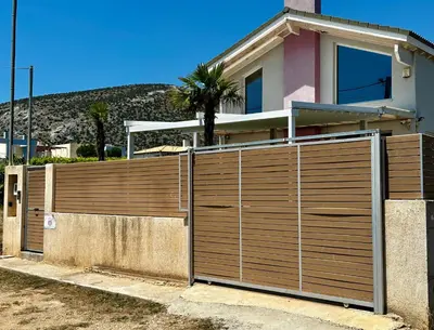a wooden fence in front of a house at GS-Vibes in Porto Rafti