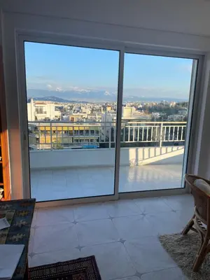 a room with a large window with a view of a city at Athens The View in Athens