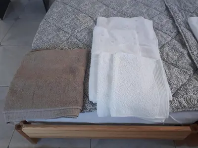 two towels are sitting on top of a bed at Athens The View in Athens