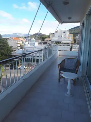 a balcony with a chair and a table at Athens The View in Athens