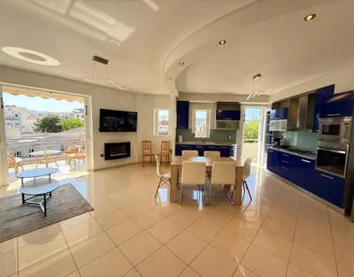 a kitchen and dining room with a table and chairs at Sunny Home Private Jacuzzi Hydromassage, Fireplace, Acropolis & Lycabettus View, Underground Parking, 300m Metro Peristeri in Athens
