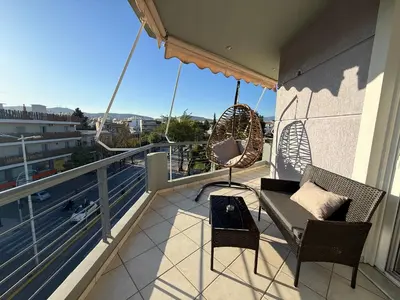 a balcony with a swing and chairs on a balcony at Sunny Home Private Jacuzzi Hydromassage, Fireplace, Acropolis & Lycabettus View, Underground Parking, 300m Metro Peristeri in Athens
