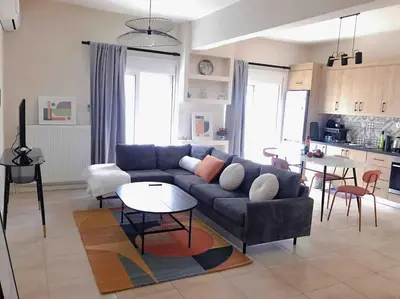 a living room with a couch and a table at Paleo Faliro Athens fully equipped 2 bedrooms 90 sqm big apartment 200m to Free beach in Athens