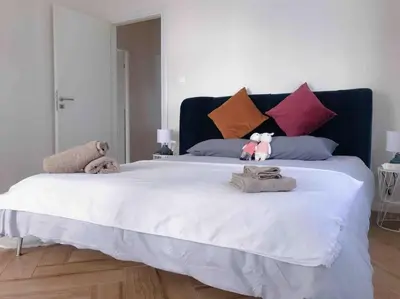 a large white bed with two stuffed animals on it at Paleo Faliro Athens fully equipped 2 bedrooms 90 sqm big apartment 200m to Free beach in Athens