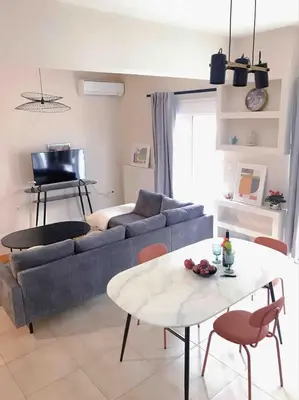a living room with a couch and a table at Paleo Faliro Athens fully equipped 2 bedrooms 90 sqm big apartment 200m to Free beach in Athens