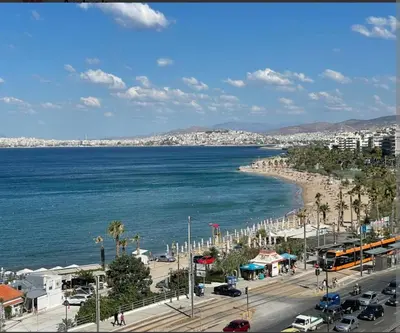 a view of a city with a beach and the ocean at Paleo Faliro Athens fully equipped 2 bedrooms 90 sqm big apartment 200m to Free beach in Athens
